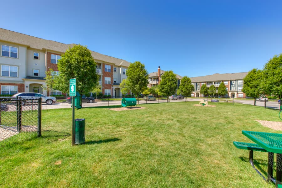 Spacious dog park with waste receptacle at apartment property