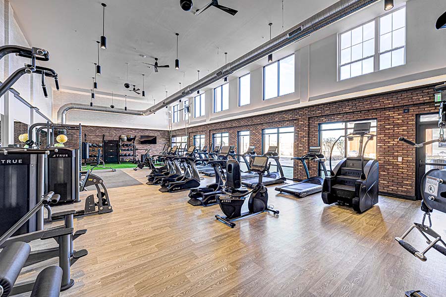 When searching for apartments, consider the amenities like this expansive fitness center at the State at Fishers. Fitness Center at the State at Fishers apartment community.