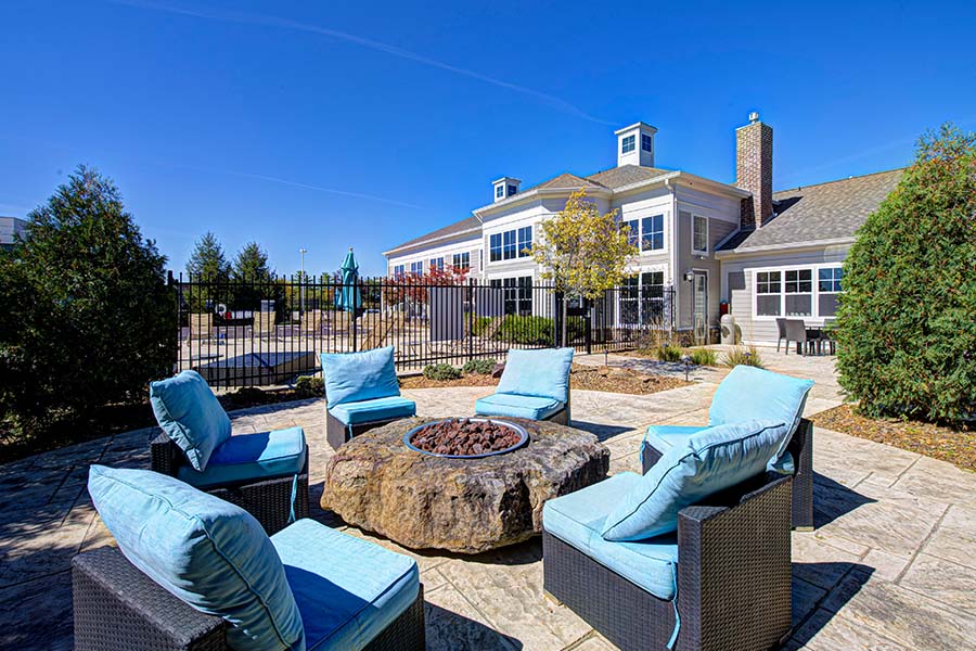 You can still find great deals during the peak season. Communities like Lakeside Apartments pictured here offer specials throughout the year. Seating area with fire pit at Lakeside Apartments of Carmel.